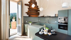 A modern kitchen with a built-in island, stainless steel appliances, and a view of the outdoors. - Luxury pool villa between Taormina and Catania, Sicily (Mascali)