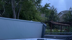 A hot tub with LED lights, surrounded by a fence and trees. - Beautiful 2 Bedroom Home In SLC with Private Hot Tub!  (Salt Lake City)