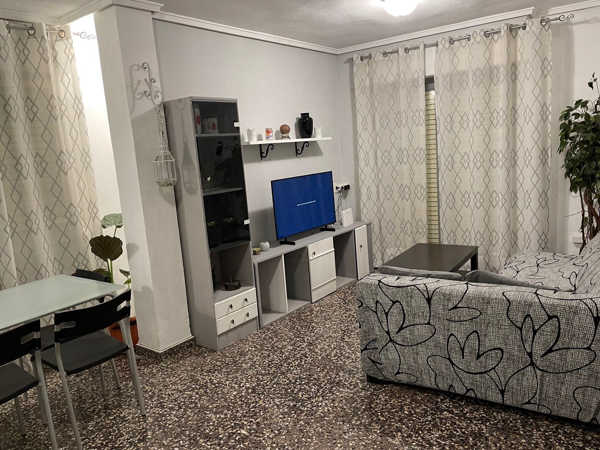 Ein gemütlicher Wohnbereich mit Küchenzeile, Flachbildfernseher, Sofa und Essbereich.