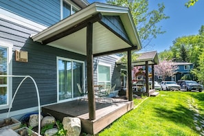 A house with a covered porch, a small garden, and a garage.