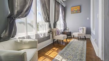 Suite Deluxe, 2 habitaciones | Zona de estar | Smart TV de 40 pulgadas con canales digitales, una televisión