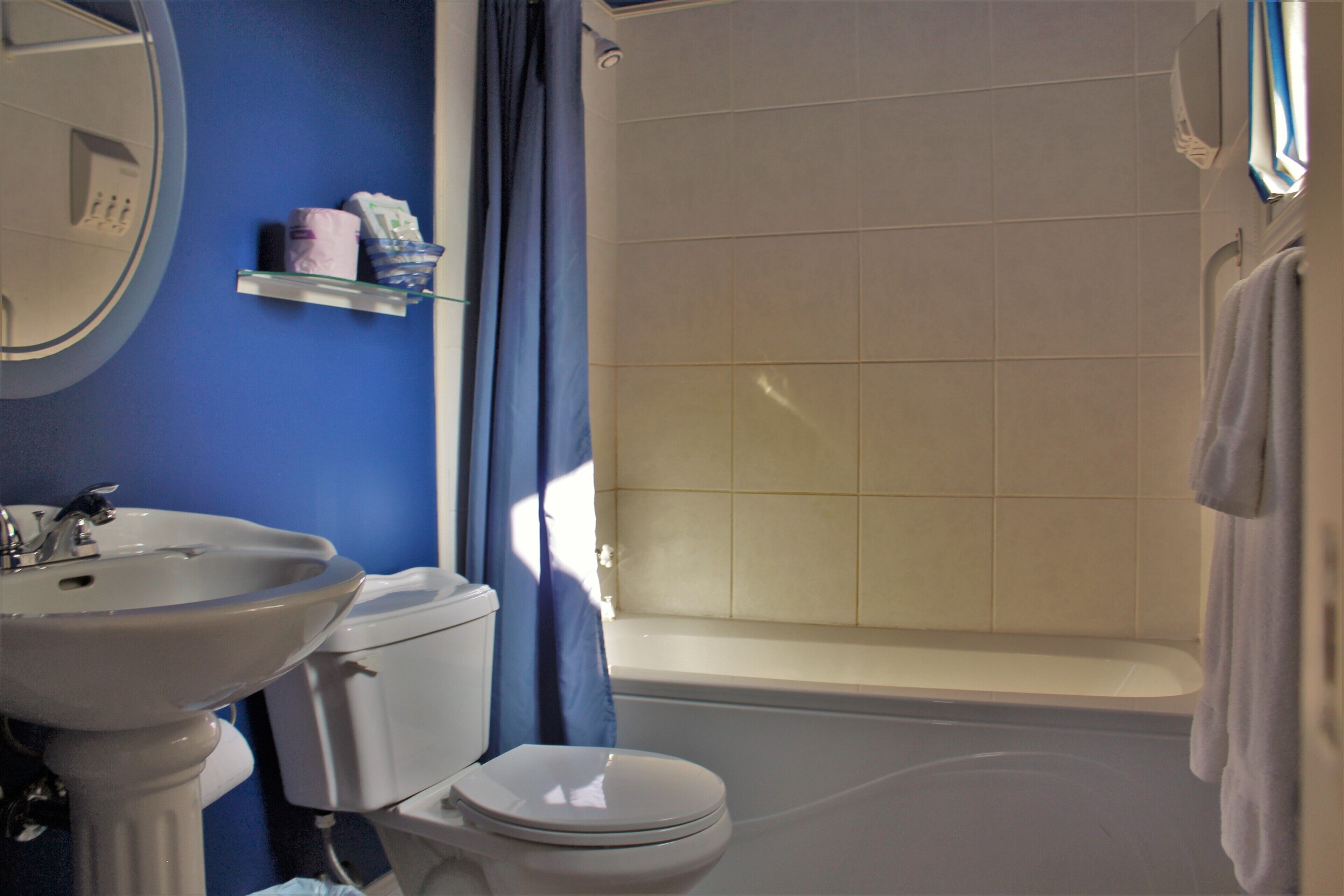 A bathroom with a sink, toilet, and bathtub.