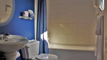 A bathroom with a sink, toilet, and bathtub.