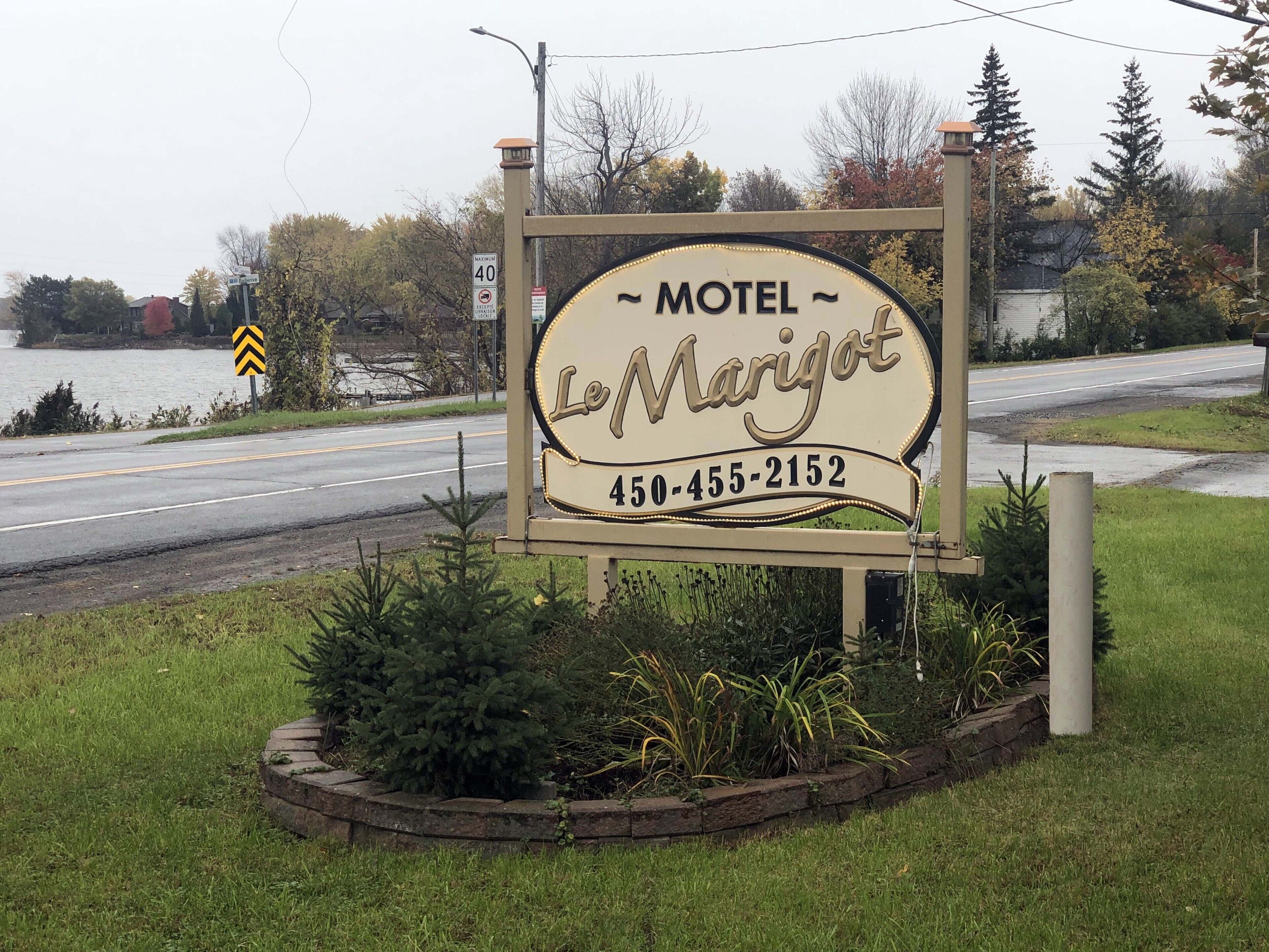 A motel sign with the name 'LeMarigot' and a phone number.
