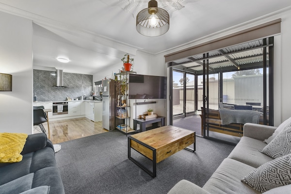 Lounge room with large sliding door access to patio. Open plan living.