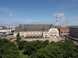 A large, historic building with a prominent tower and a central courtyard.