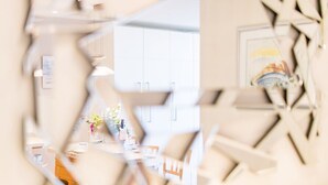 Een modern interieur, met zichtbare keukenruimte achter een glazen wand.