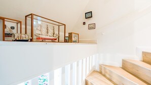 A staircase with wooden steps and a white railing. - Twesk Diker 3, Germany (Sylt-Ost)