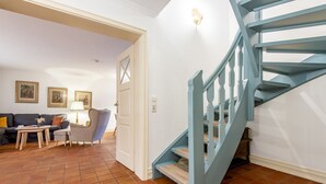 Una escalera con barandillas azules que sube a un piso superior.