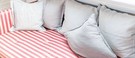 A bed with striped bedding and pillows.