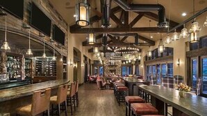 A bar area with wooden beams, hanging pendant lights, and bar stools. - Zen Retreat, Amazing Views, Minutes to Attractions (Sedona)