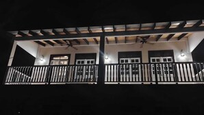 A two-story building with a balcony and a covered area. - The Cedar Canalfront Penthouse (Nassau)
