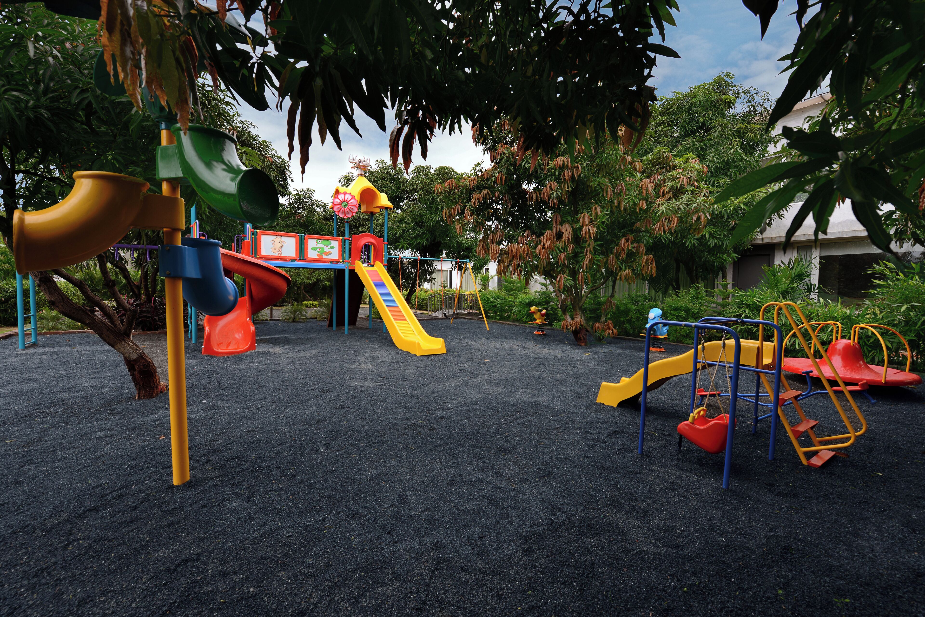 A playground with multiple slides and climbing structures.
