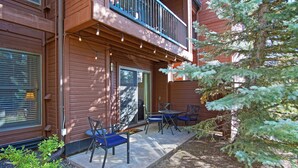 A wooden building with a balcony, outdoor seating, and a tree. - Private Shuttle in Winter, Free Bus Route, Convenient Location + Hot Tub & Pool (Steamboat Springs)