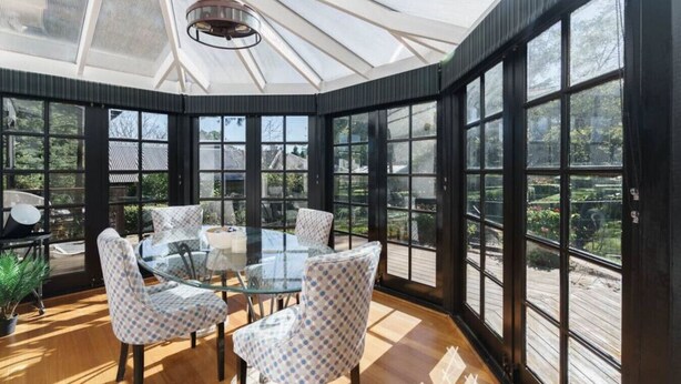 A conservatory with a glass table and chairs, surrounded by large windows. - Bryn-y-Mor Cottage/ Romantic / Fireplace/Couples (Leura)