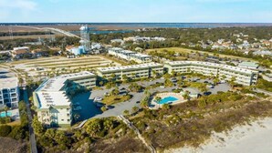 A resort with multiple buildings, a swimming pool, and a water tower. - 3rd Floor Condo w/Amazing Ocean View! Pool & Pier Access! *Unit 328* (Isle Of Palms)