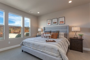 A bedroom with a large bed, two bedside tables, a nightstand, and three framed pictures on the wall. - Paseos 1149 | Desert Pete's Retreat SLP 20 | Private Swim Spa and Hot Tub, and Putting Green (Washington)