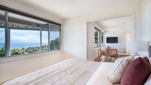 A bedroom with a large window, a bed, a desk, and a chair. - Pet Friendly - Cook's Lookout McCrae (McCrae)