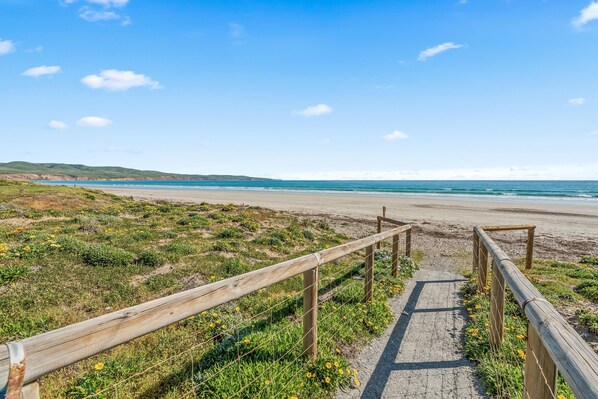 A wooden pathway leading to a beach with a clear view of the ocean. - The HardyOne ~ Aldinga Beach - Stunning Abode in Serene Silver Sands (Aldinga Beach)