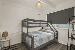 A bunk bed with a window, a small table, and a hanging light fixture. - The HardyOne - Aldinga Beach - C21 SouthCoast Holidays (Aldinga Beach)