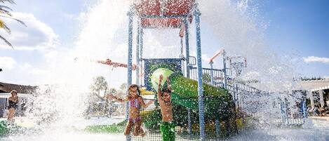 A water play area with a structure and water jets.