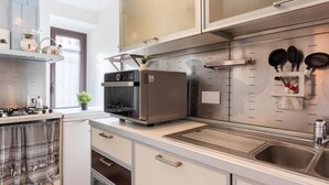 A modern kitchen with stainless steel appliances, a built-in oven, and a wall-mounted drying rack. - GuestHost - Cozy 70 sqm apartment, perfect for two people, located on the third floor of a period building in good condition with a lift (NOT suitable for disabled people). The property is located along via Etnea, the main shopping street in Catania, and (Catania)