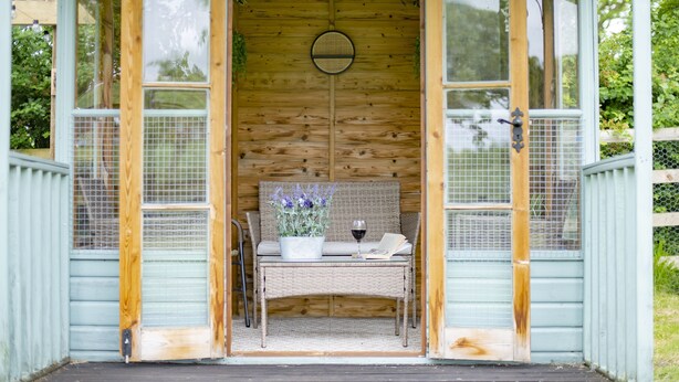 A wooden gazebo with a bench, a potted plant, and a glass of wine. - Lime Kiln Farm, Malton, North York Moors (Malton)