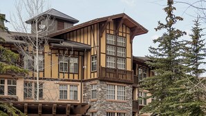 A multi-story building with a stone facade and a wooden balcony. - Apex View by Cottonwood Lodging (Solitude)