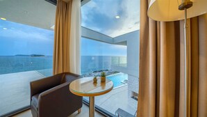 A modern room with a glass table, a leather chair, and a view of the sea. - Villa Valiosa - stunning beachfront villa with a pool and a sauna for ten guests by MyWaycation (Rogoznica)