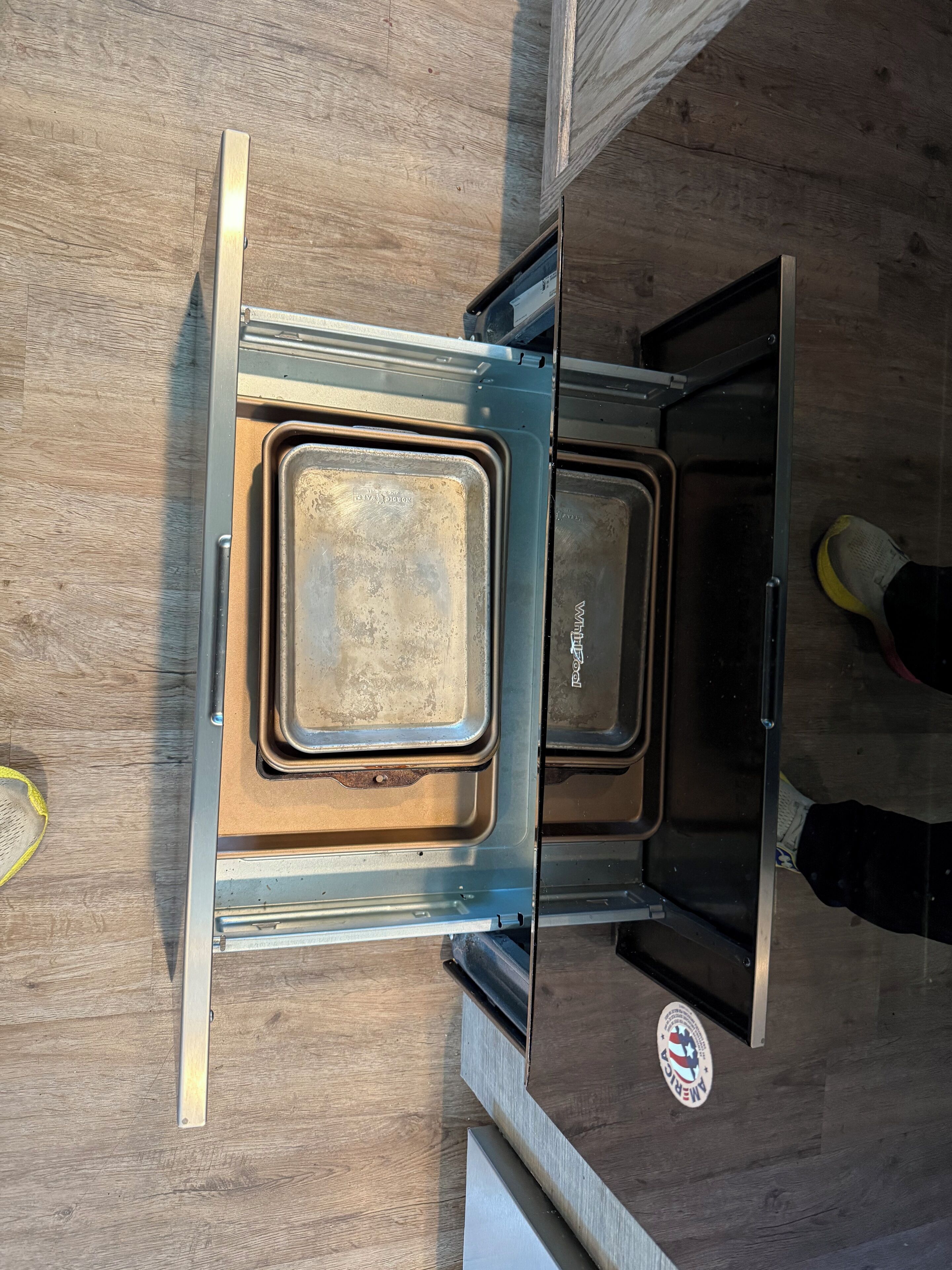 A kitchen with a built-in oven and a microwave.