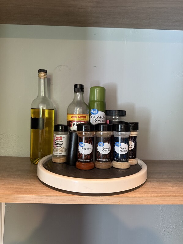 A shelf with various kitchen condiments including oil, vinegar, and spices. - Blue Hole at Pigeon Mtn. Wildlife Mgmt Area in North Georgia (LaFayette)