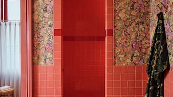 Deep soaking tub, rainfall showerhead, designer toiletries, hair dryer
