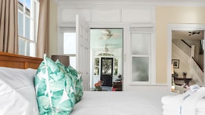 A hotel room with a bed, a view of the outside, and a staircase. - Where Tranquility Blooms | Blossoms on Cannon (Charleston)