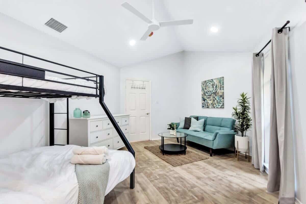 This bedroom combines a Twin-Over-Queen bunk bed with lounge seating, giving guests room to share and relax.
