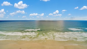 A beach with clear blue sky and calm sea. - Oceanfront Penthouse ~ Professionally Designed (Daytona Beach Shore)