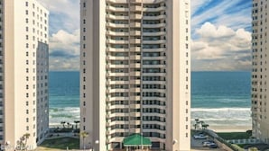 A high-rise hotel with multiple balconies, a beach view, and a parking area. - Oceanfront Penthouse ~ Professionally Designed (Daytona Beach Shore)