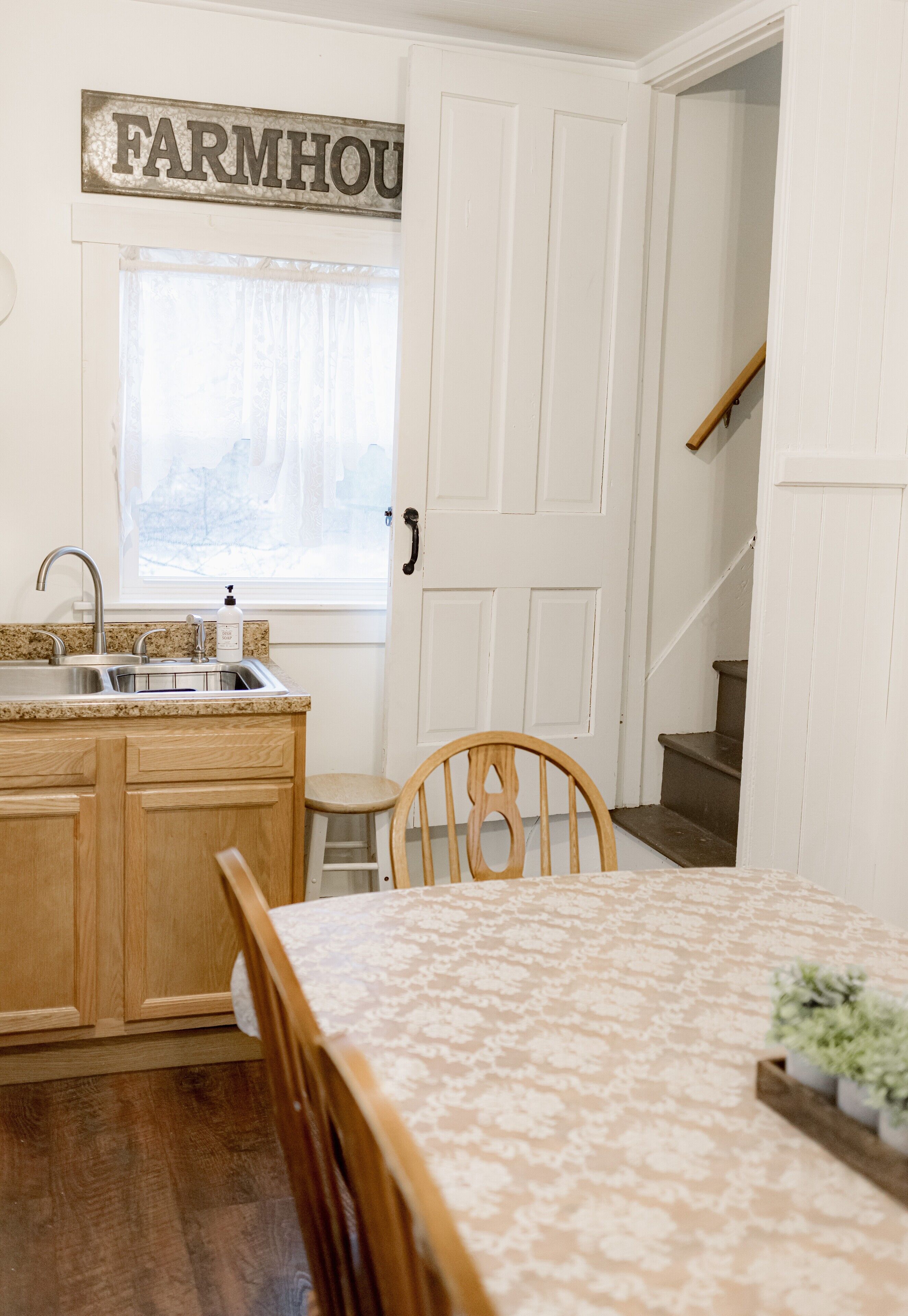 A kitchen with wooden cabinets, a sink, and a window.