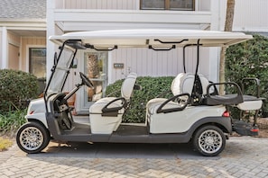 A golf cart parked in front of a building with a number 757 sign. - "Pipers Perch" - Book Fall Break with Golf Cart! (Miramar Beach)
