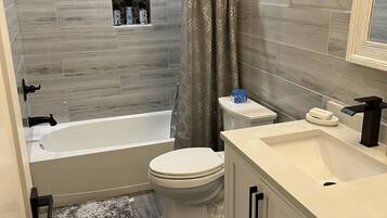 Bathtub, towels, soap, shampoo