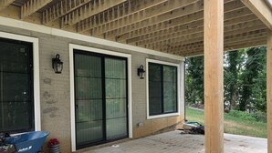 A covered porch with a concrete floor, large windows, and a wooden ceiling. - Modern newly private basement apartment  (Alexandria)
