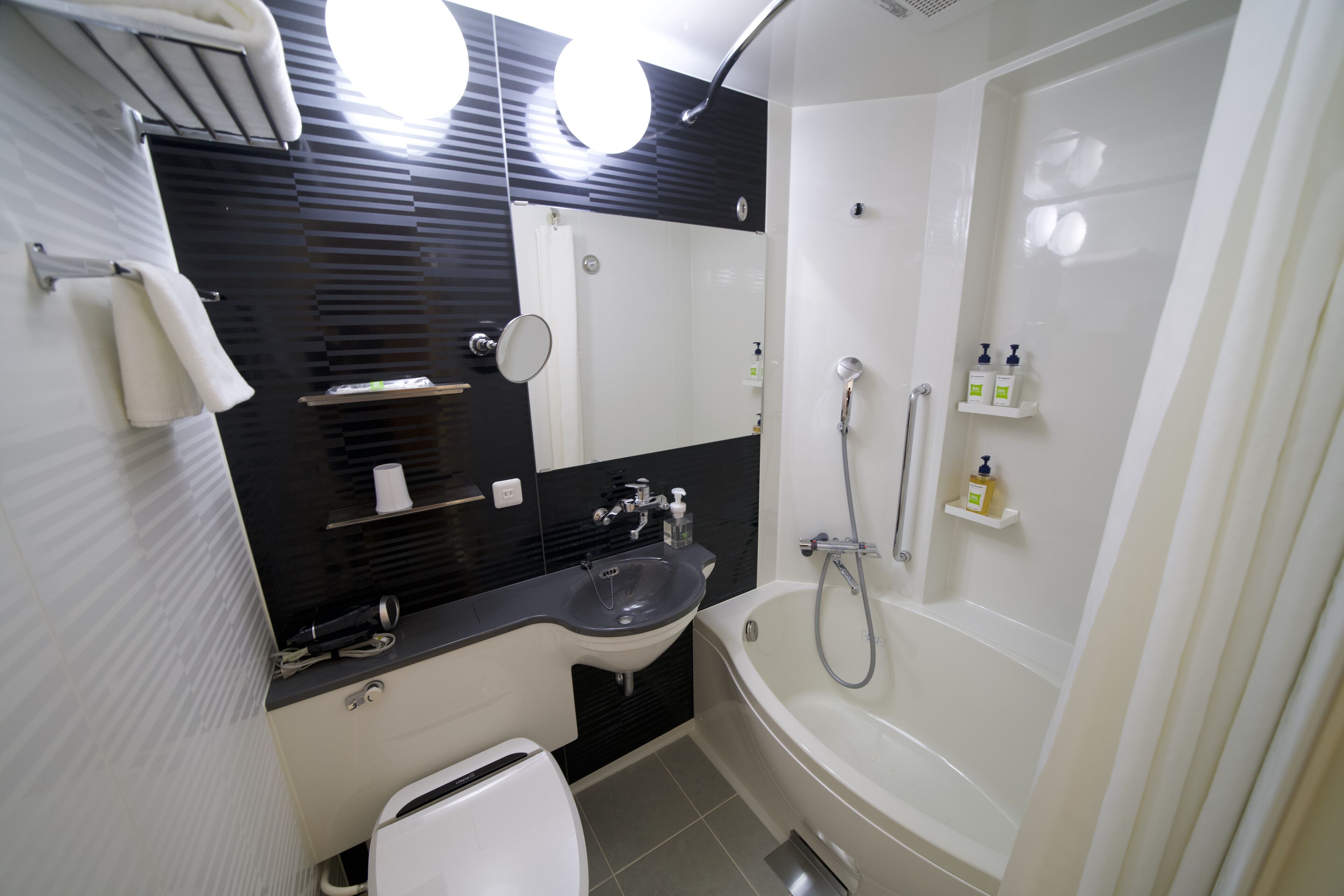 eco-friendly toiletries, hair dryer, slippers, towels