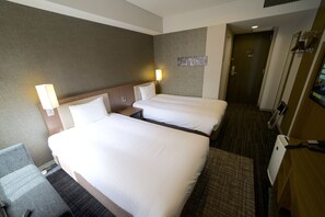A hotel room with two beds, a desk, and a chair. - ibis Styles Tokyo Ginza (Tokyo)
