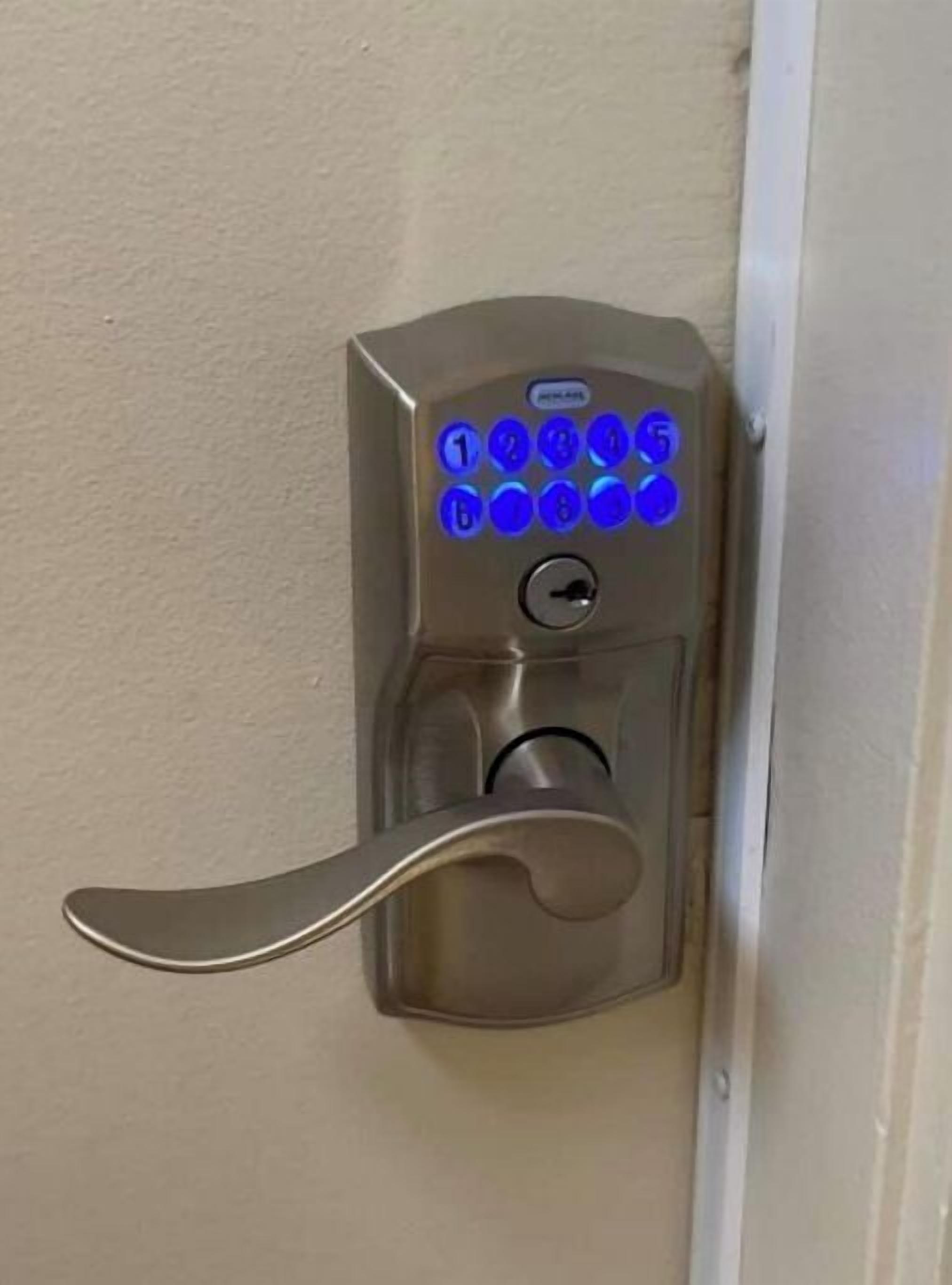 A door lock with a numeric keypad and a keyhole.