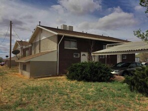 Two-story house with a garage and an outdoor space.