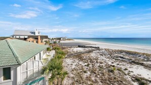 A beachfront property with a large house, a beach, and a clear sky. - Third Floor End Unit,  Beach service included, 2 chairs & 1 umbrella, Mar-Oct (Santa Rosa Beach)