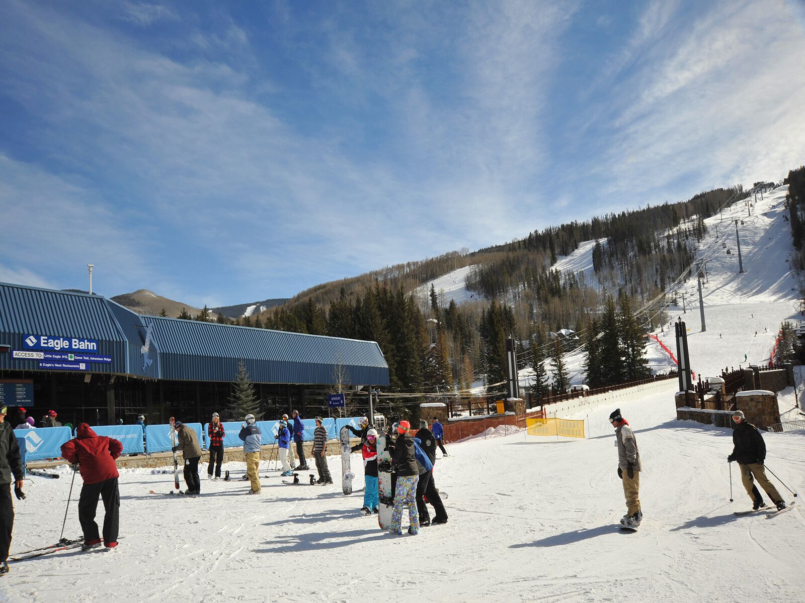 A ski resort with a building labeled "Eagle Bahn" and a ski slope in the background.