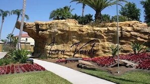 A rock formation with the inscription "Terra Verde" and a flagpole with a red flag. - 3BR Townhome Near Disney I Resort Pool, Hot Tub & Disney-Themed Room (Kissimmee)