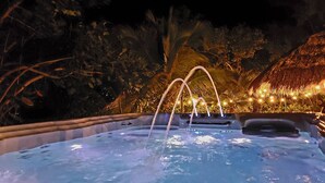 A hot tub surrounded by tropical foliage and string lights. - 200ft of Waterfront with Tiki & Heated Pool - Boaters Paradise  (Key Largo)