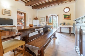 A spacious kitchen with wooden benches, a large table, and a dining area. - Villa in Pesaro with 4 bedrooms sleeps 10 (Novilara)