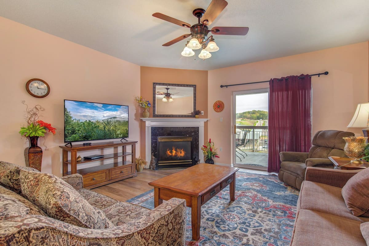 A living room with a fireplace, television, and seating area.